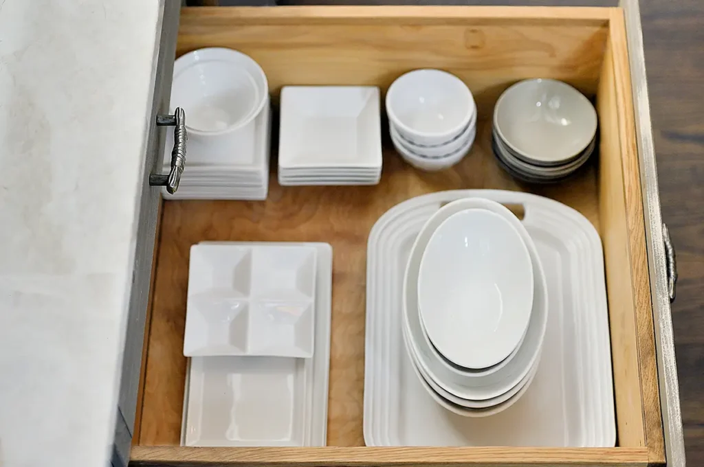 Organized guest-ready vacation rental kitchen in Santa Fe, NM with dishes and supplies prepared for guests